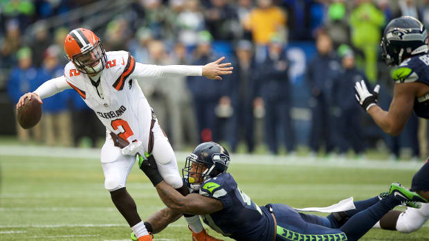 Cleveland Browns quarterback Johnny Manziel (2) get away a pass as he is tackled Seattle Seahawks linebacker Bruce Irvin (51) during a game at CenturyLink Field.